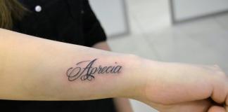Kirill inscription tattoo on arm